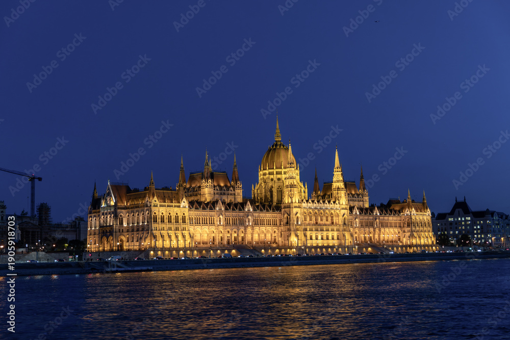 Fototapeta premium Illuminated Hungarian Parliament Building and Danube river at the night. Budapest capital od Hungary.