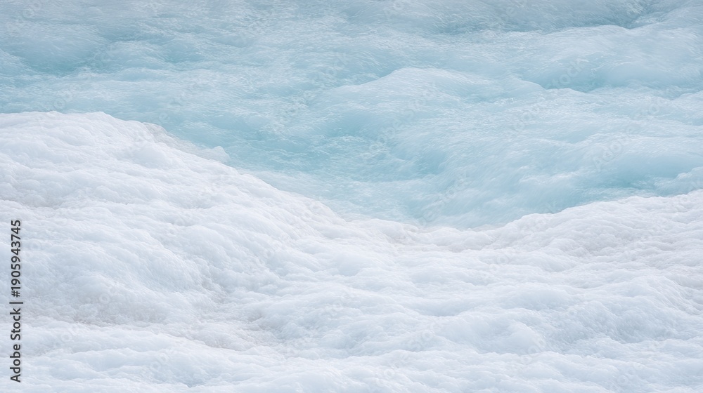 Obraz premium White frothy water waves mixing with light blue water in a natural setting, showcasing the dynamic textures and patterns of aquatic movement