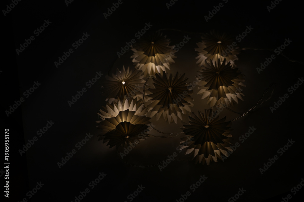 Fototapeta premium Light garland on a black background. Evening lights.