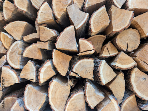 Close-up of a background of dry chopped firewood stacked in rows.