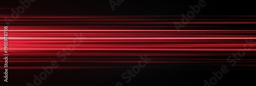 Red, glowing light speed lines on a black background. Abstract, motion-blurred streaks with grain noise