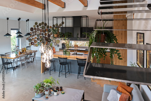 Home interior with metal stairs in electic style. Modern living room in modern house. Indoors architecture. Home decor and Real estate.