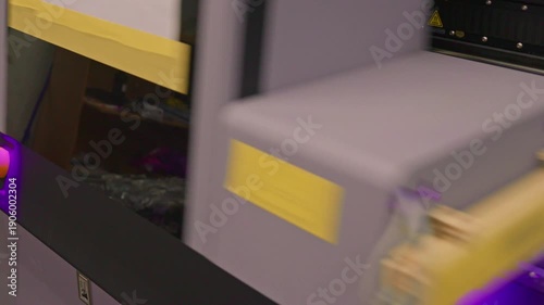 4K footage of a UV flatbed printer simultaneously printing an image on ten mobile phone case. Modern industrial digital printing process for custom phone accessory production.