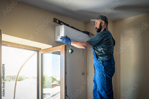 Professional master is checking out level of conditioner block. Split system