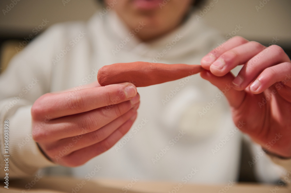 Obraz premium Child Molding Clay At Home, Hands Shaping Brown Dough In Focused Hobby Session