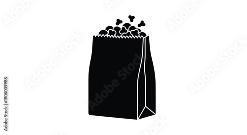 A black paper bag overflowing with popcorn a stark silhouette