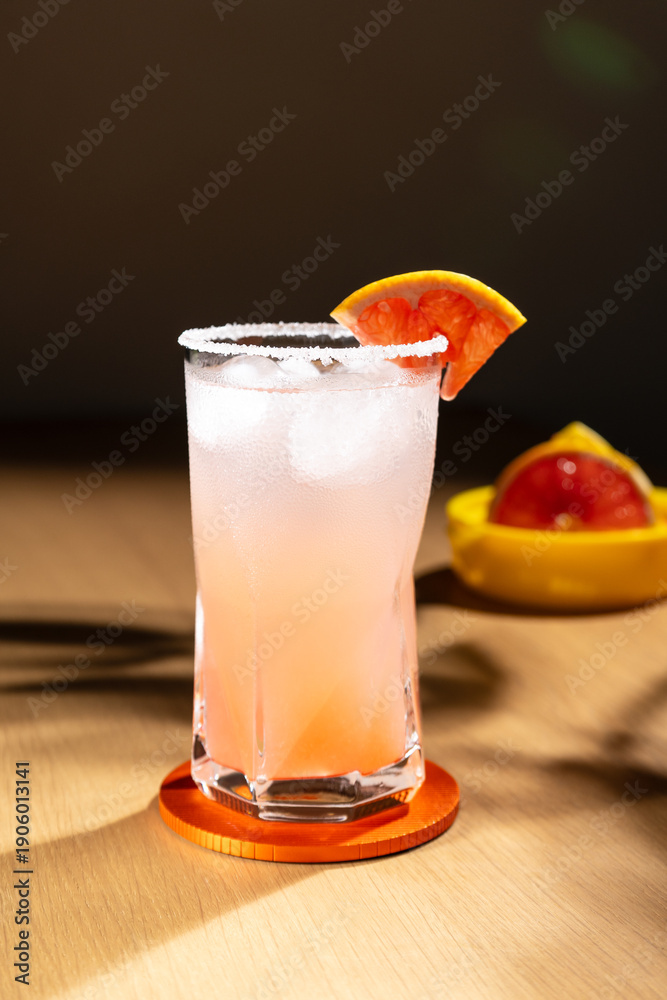 Fototapeta premium Cold grapefruit cocktail in a highball glass.