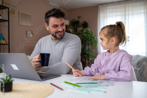 Obraz na plátně Father and daughter spend time together at home while making art in the living r