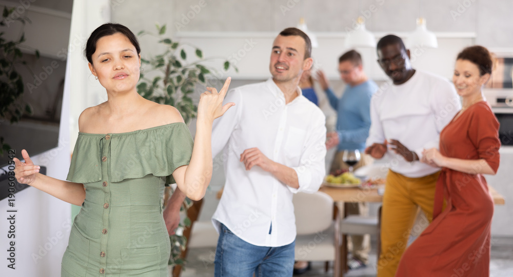 Obraz premium Positive friendly pairs in their middle years dancing actively in warm home environment