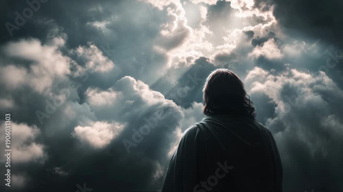 Jesus stands with his back to the viewer under a sky of clouds and light in a powerful moment of reflection and connection