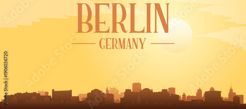 Golden yellow panoramic poster of the city skyline with misty background buildings and clouds of BERLIN, GERMANY