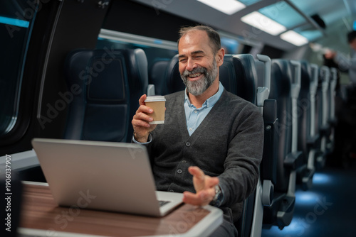 Fotografie Mature man working on laptop during train commute