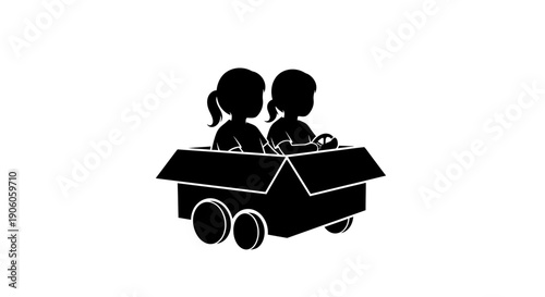 Two children playing together in a cardboard box on wheels.