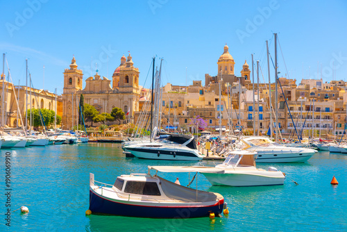 Historic Grand Harbour of Malta, focusing on the picturesque waterfront of Birgu with its traditional boats and Baroque architecture. Marina scene featuring numerous docked sailboats and motorboats