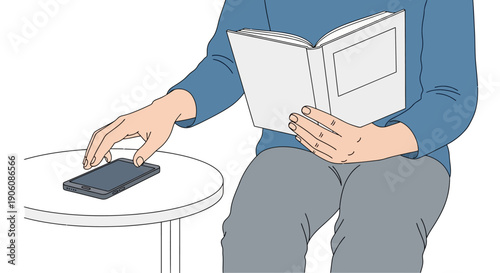 A person reading a book while using a mobile phone on a small table indoors