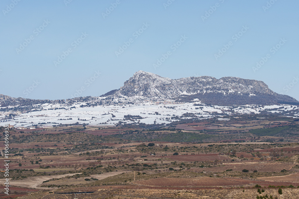 Fototapeta premium Snowy Mountain Ridge and Farmland Near Logrono, Spain