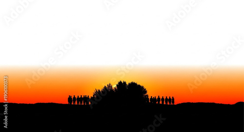 Silhouette of a group of people standing together at sunset.
