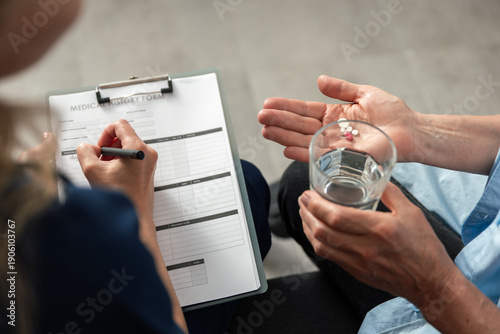Vászonkép Doctor visits patient at home to discuss medication and health management