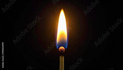 A striking flame ignites on a matchstick in the dark, symbolizing energy and illumination. The fire's warm colors and intense glow create a captivating contrast against the darkness