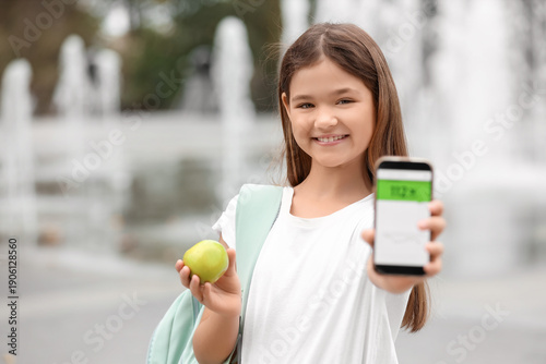 Teenage diabetic girl with apple and mobile app for sugar level measuring in ...
