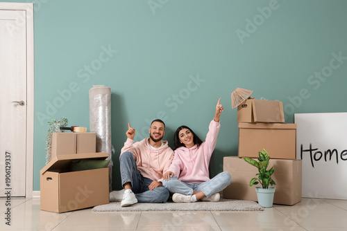 Happy young couple pointing...