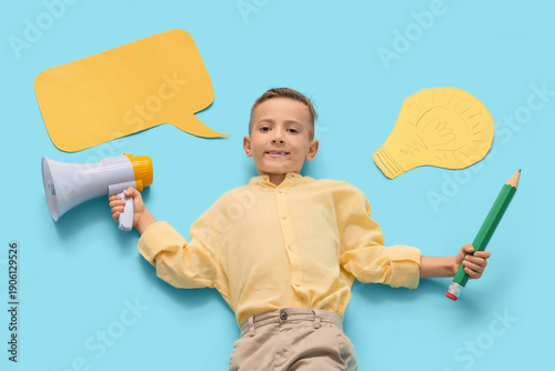 Cute little schoolboy with large pencil, megaphone and blank speech cloud on ...