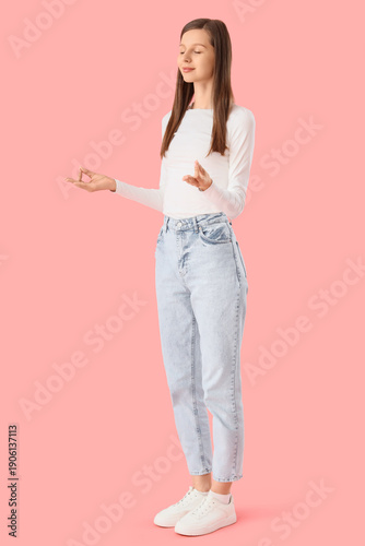 Young woman meditating on p...