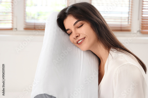 Young woman in pajamas hold...