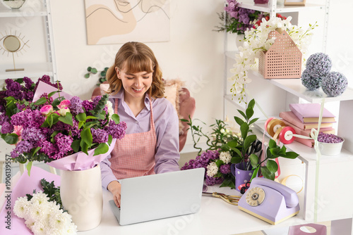 Female florist with laptop ...