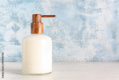 Soap dispenser on white tab...