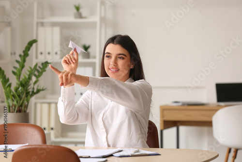 Young businesswoman with pa...