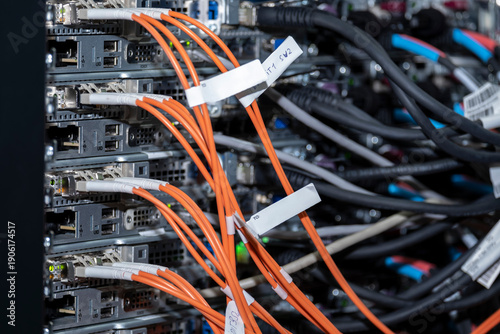 Fiber optic cables and connectors plugged into servers. Modern IT and telecom infrastructure. Ideal for technology, networking, data transmission, and high-tech concepts.