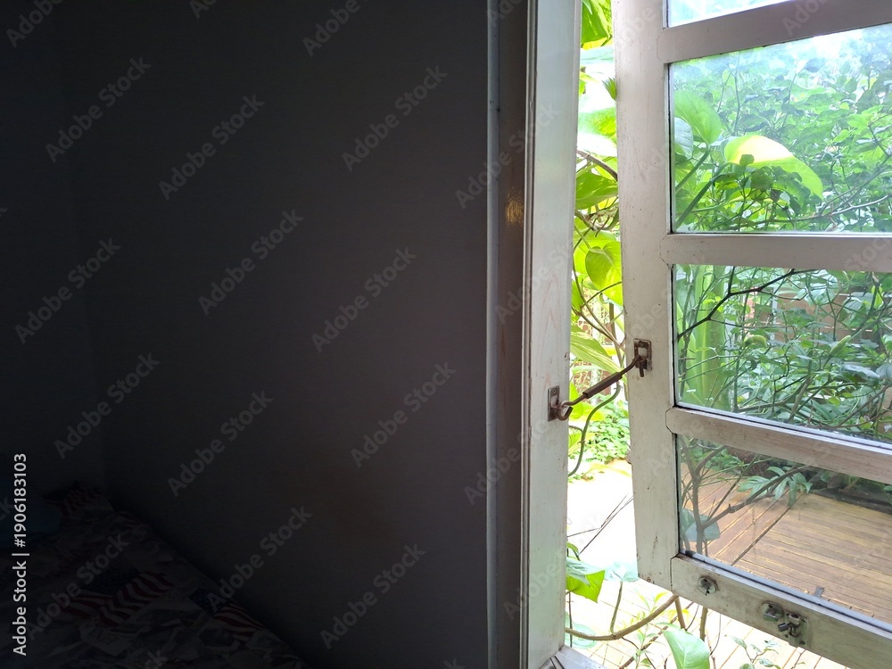 Obraz premium Open Window with Green Plants and Natural Light from Garden