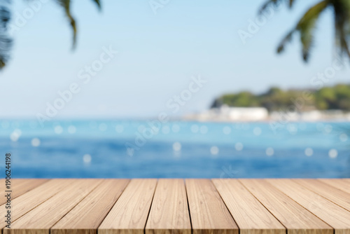 Fotografie Empty wooden table or plank bench or boardwalk bridge across blue sea and island under summer sky