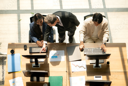 Wallpaper Mural Business colleagues working together at computers while a manager gives guidance Torontodigital.ca