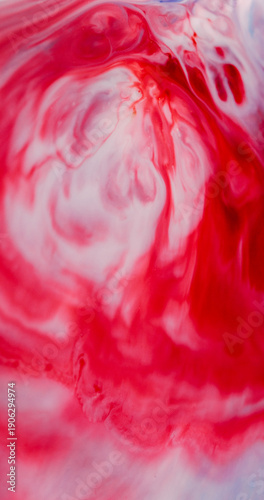 Wet blob defocused. Paint spill. White acrylic drop fluid curl wave blend color on red background. Abstract art splotch splash explosion.