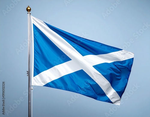 Scottish Flag Waving in the Wind Against a Clear Blue Sky.