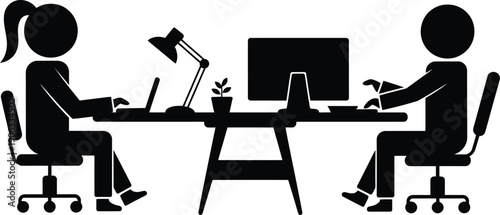 Two people sitting at a desk working on computers
