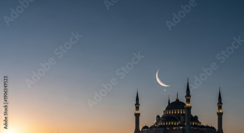 Mosque silhouette at sunset with crescent moon in evening sky