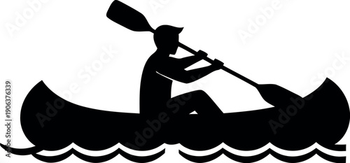 Silhouette of a person rowing a canoe on a body of water