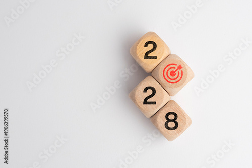 Happy new year 2028, modern minimal banner. Business goal plan, building success concept. 2028 year numbers with target icon on eco wooden hexagon blocks isolated on blue background with copy space.