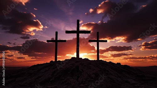 Three crosses on a hill silhouetted against a dramatic sunrise. The crucifixion of Jesus Christ at Calvary. A symbol of christianity, faith, and easter