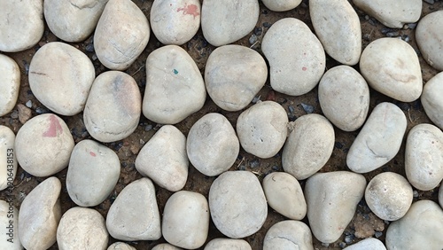 Texture of large smooth stones decoratively laid out on the ground