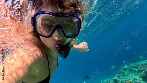 Snorkeling in the Red Sea With a Woman Exploring the Underwater World Near the Reef and Its Colorful Fish