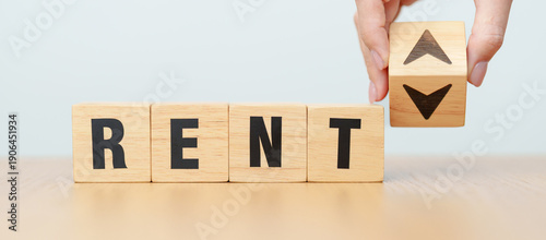 Konstfotografi hand change wooden block with RENT text to UP and Down arrow