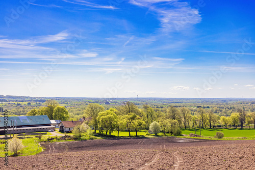 Rural landscape view with a farm in the countryside a sunny spring day