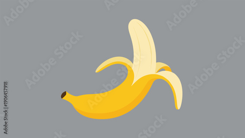 Single yellow banana partially peeled on a flat gray background illustrates healthy food, nutrition, and tropical fruit snacks.