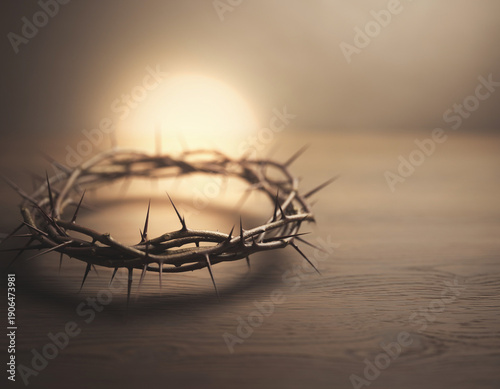 A metal crown of thorns and intertwined barbed wire fence surrounds the steel globe design on a black background like a sharp ornament