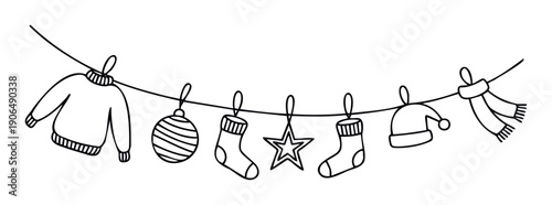 Festive winter and Christmas decorations with warm clothing items like a sweater, socks, hat, and scarf hanging on a line, ideal for holiday branding and seasonal designs.
