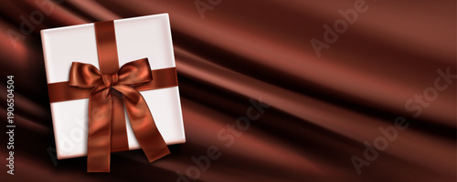 Brown silk flowing background with white gift box, satin ribbon with bow, realistic vector illustration. Elegant velvet bg, top view. Premium present banner for birthday celebration or special event